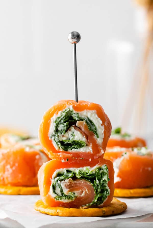 salmon and spinach rolls with a toothpick in the middle.