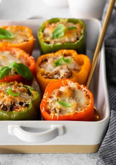 stuffed peppers in a white baking dish.