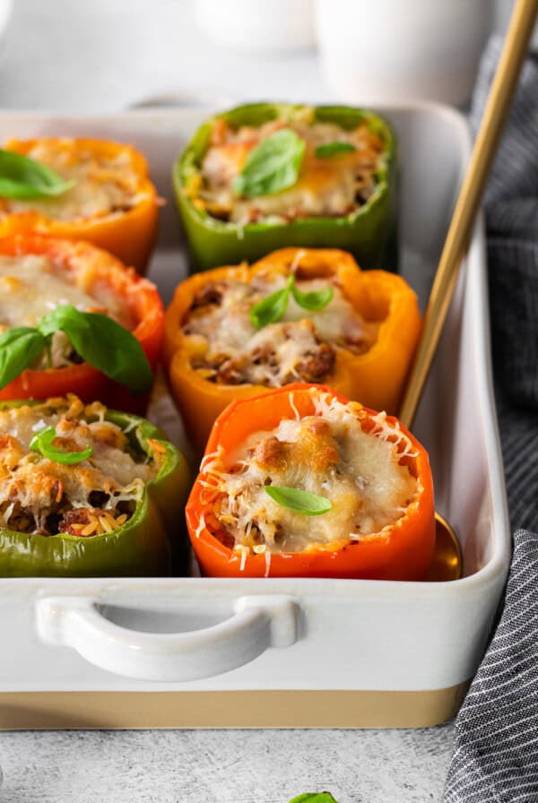 stuffed peppers in a white baking dish.