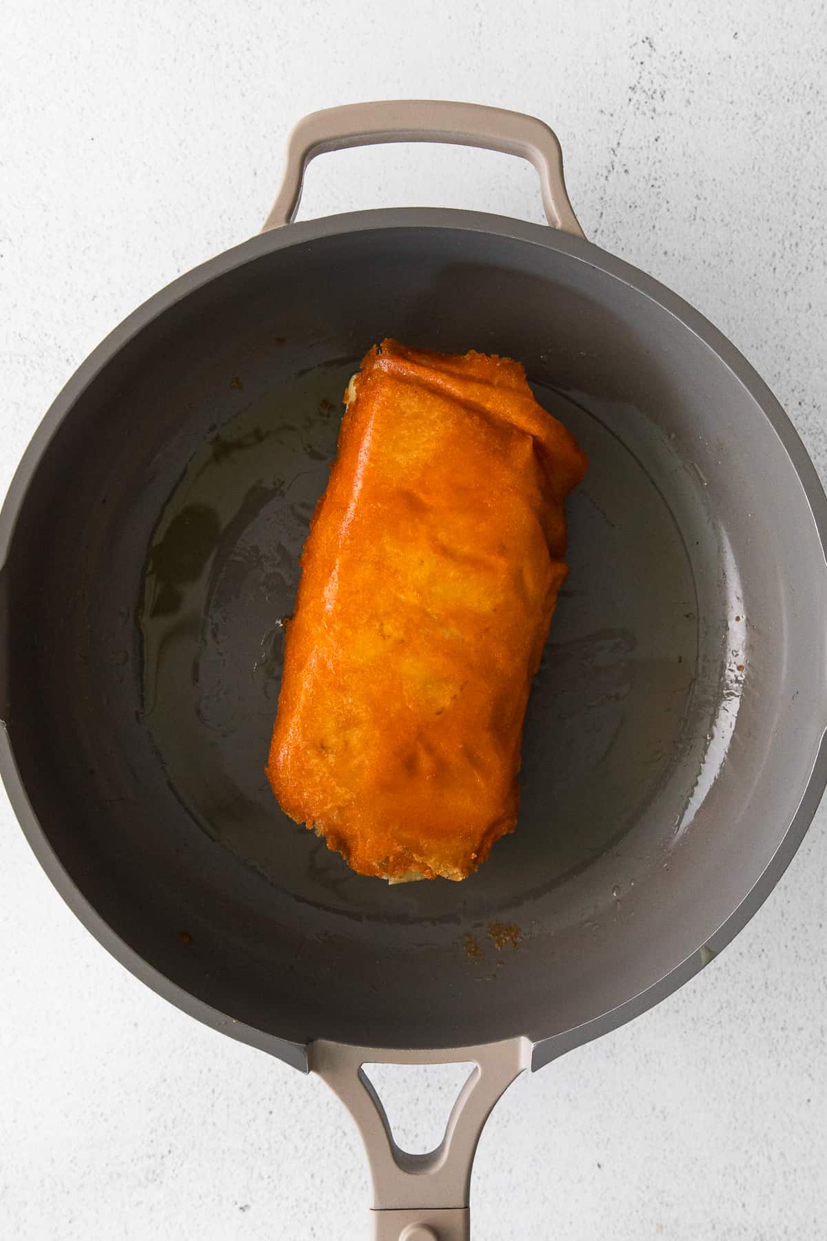 Taco Bell Grilled Cheese Burrito in the pan. 