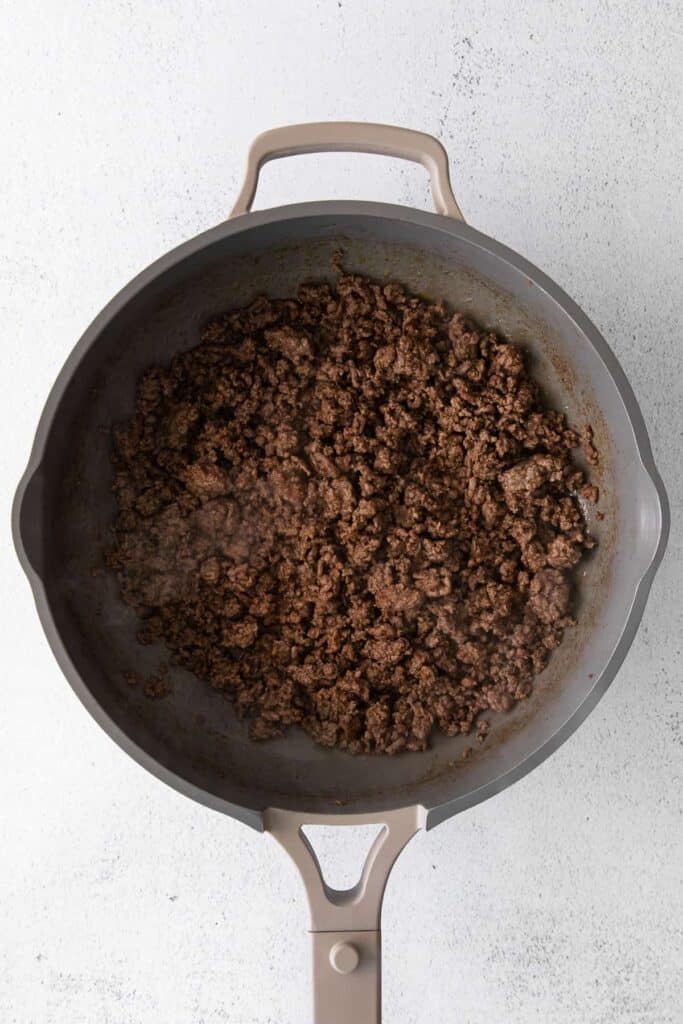 Seasoned ground beef in a skillet pan. 