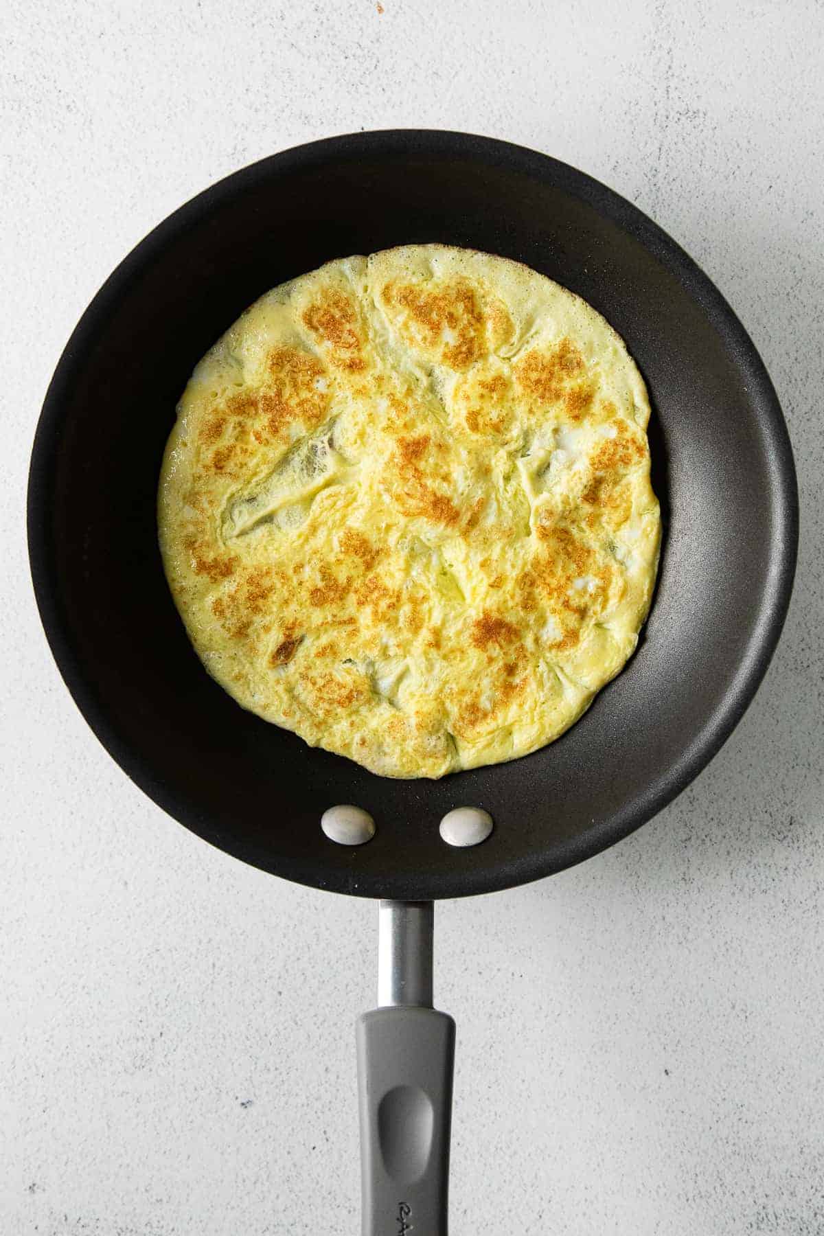 egg being cooked in a skillet