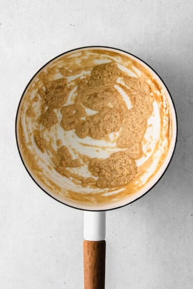 a frying pan with cheese sauce for broccoli in it.