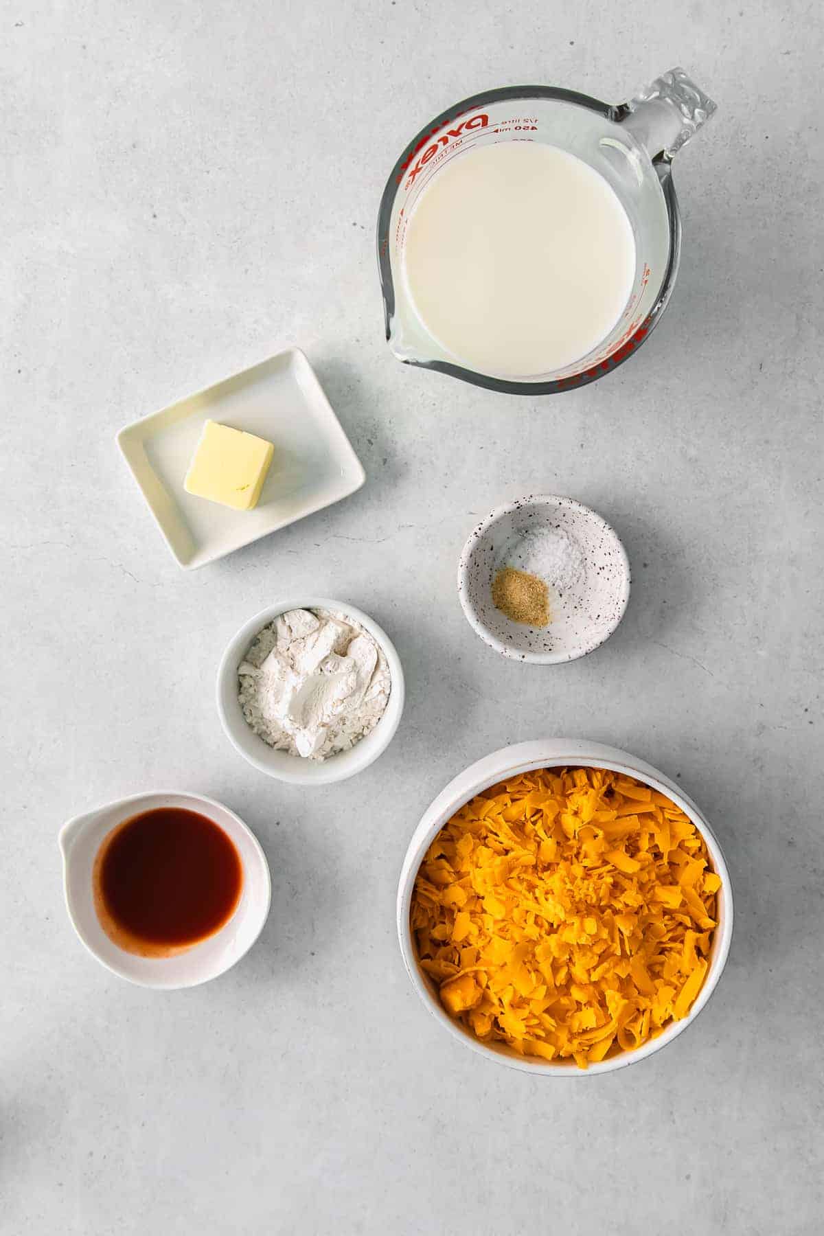 All the ingredients for the broccoli cheese sauce in bowls. 