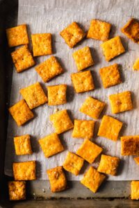 cheesy crackers on a baking sheet.