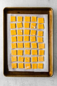 squares of cheese on a baking sheet.