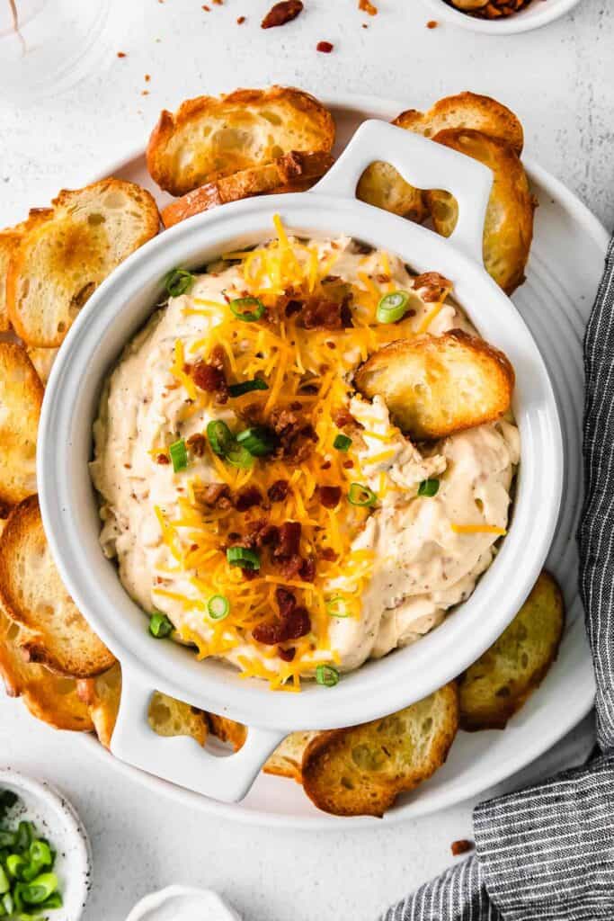 chicken bacon ranch dip in a bowl surrounded by crostini