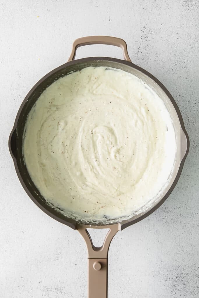 creamy cream cheese pasta sauce in skillet.