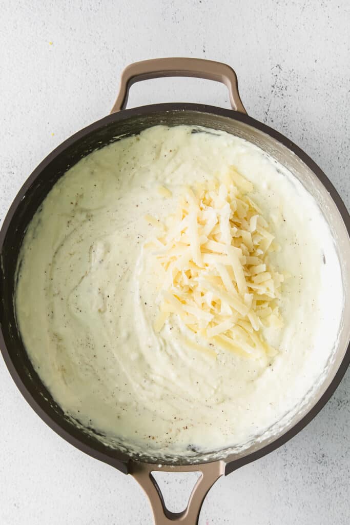 shredded cheese on cheese sauce.