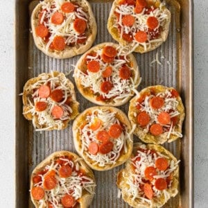 pepperoni pizzas on a baking sheet.