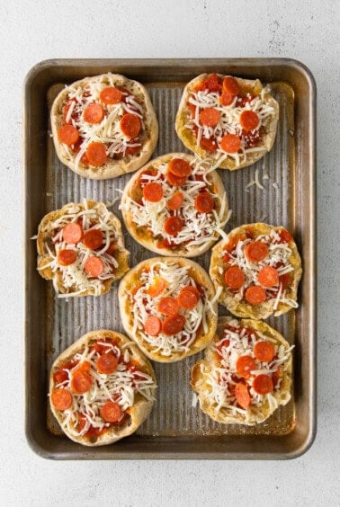 pepperoni pizzas on a baking sheet.