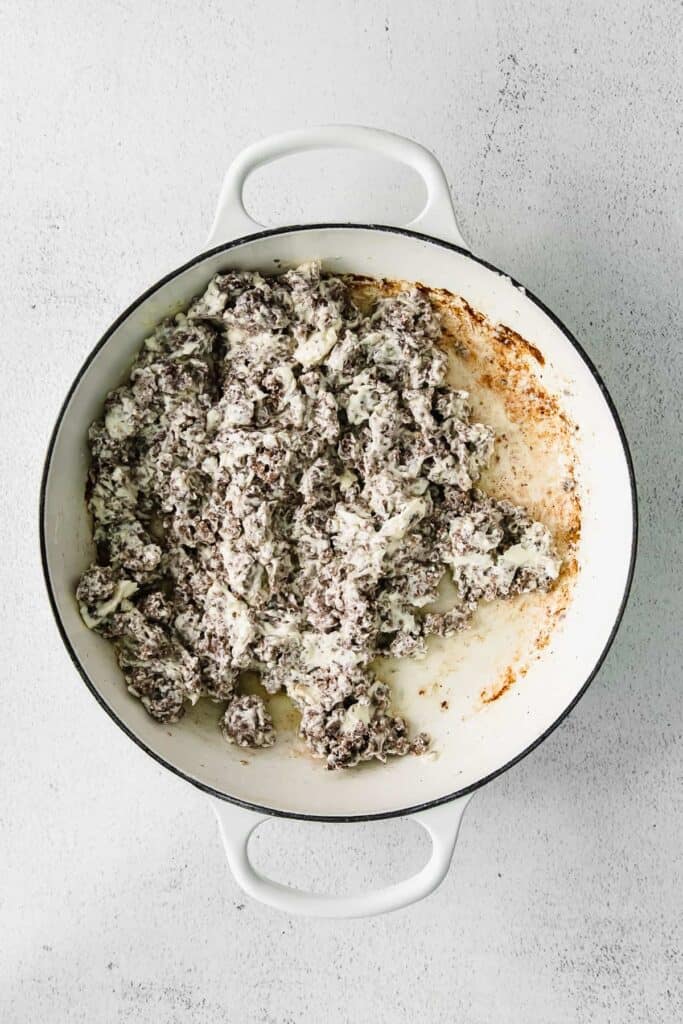 Ground beef and cream cheese in a skillet pan. 