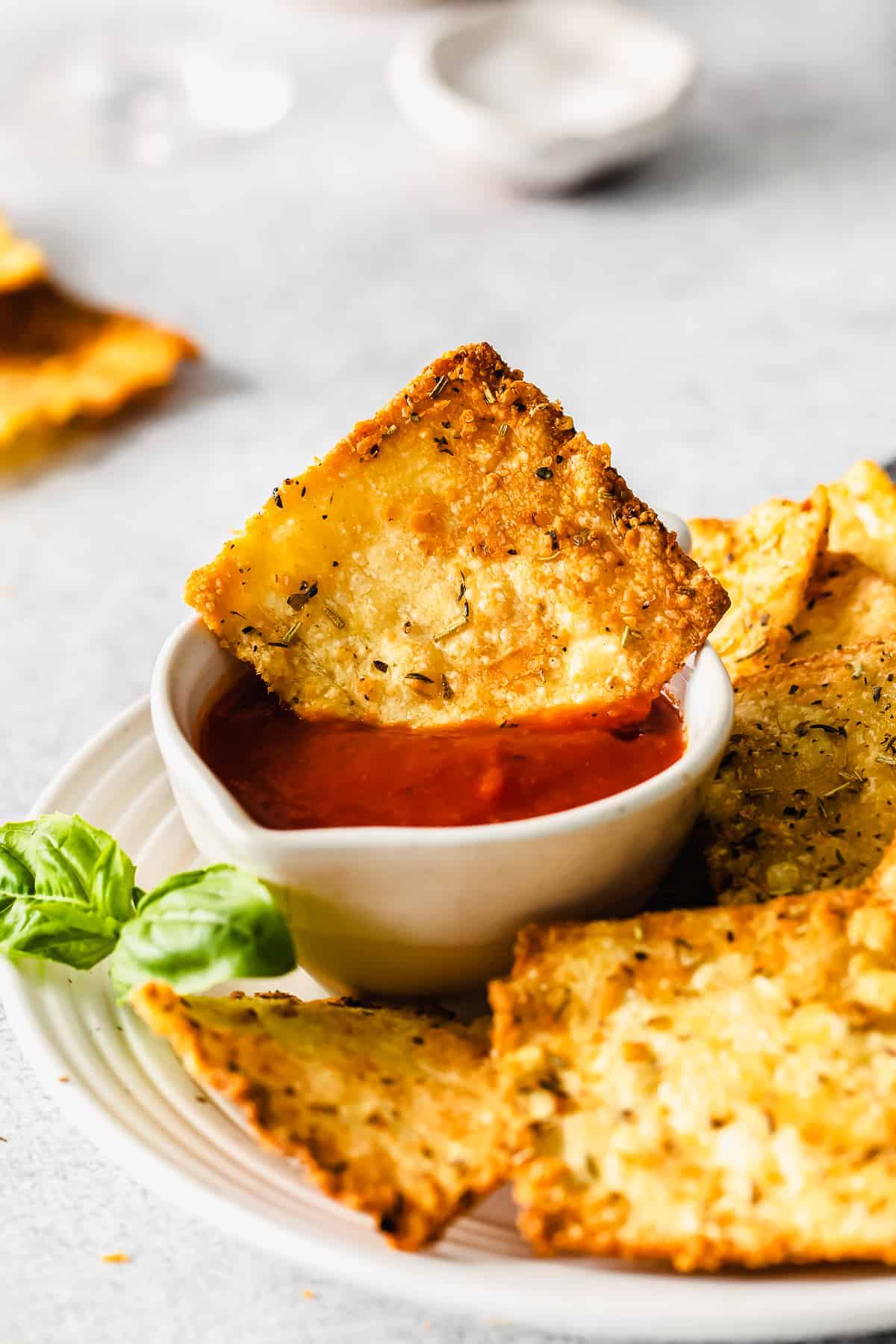 dipping pasta chips into marinara sauce