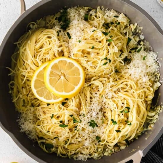 lemon spaghetti in a skillet with parmesan cheese.