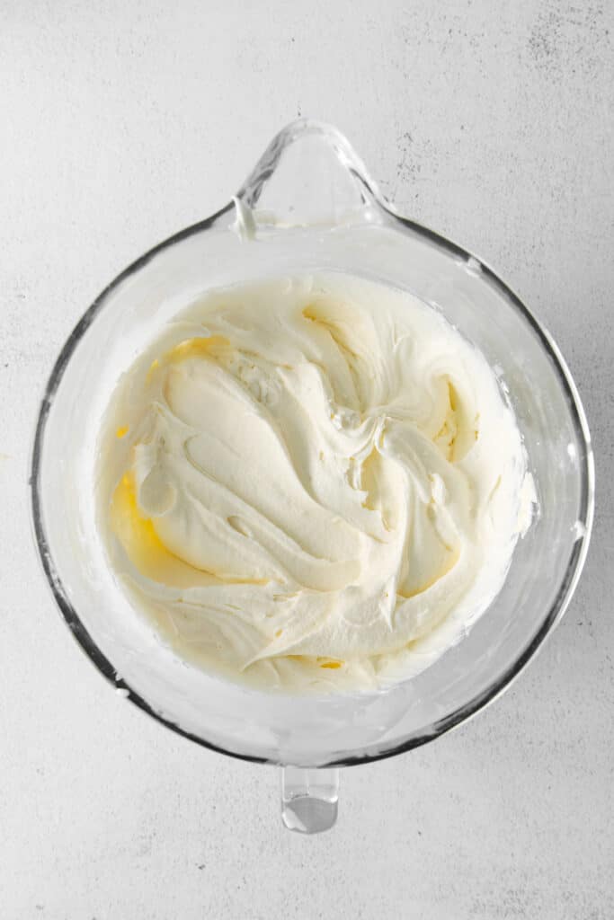 Fluffy cream cheese frosting in a bowl. 
