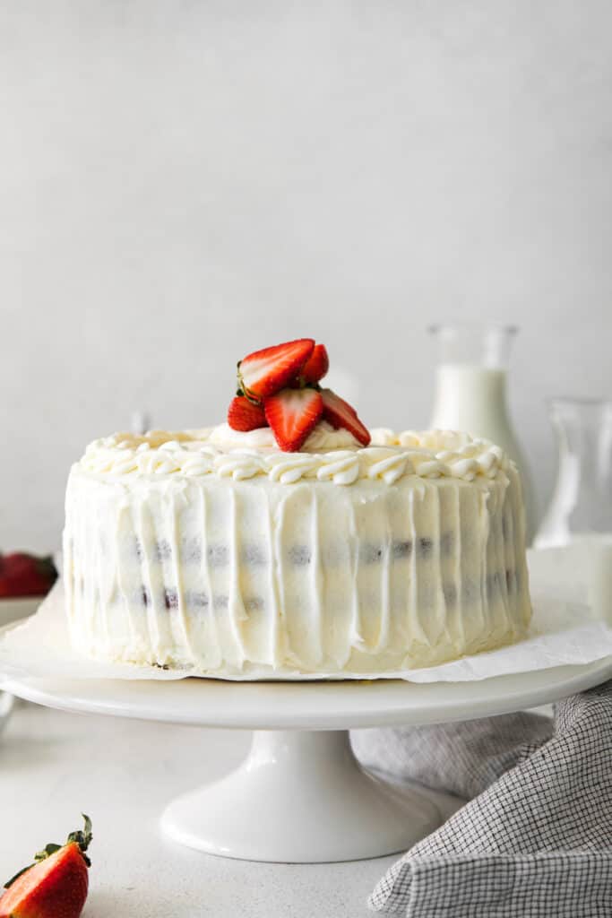 Strawberry ricotta layer cake with fresh strawberries on top. 