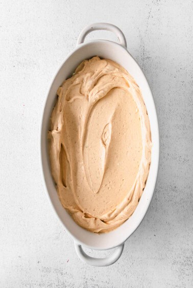 a white dish with a whipped cream in it.