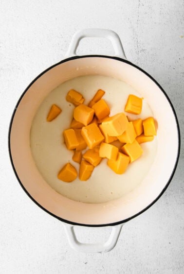 mixing velveeta cheese sauce.