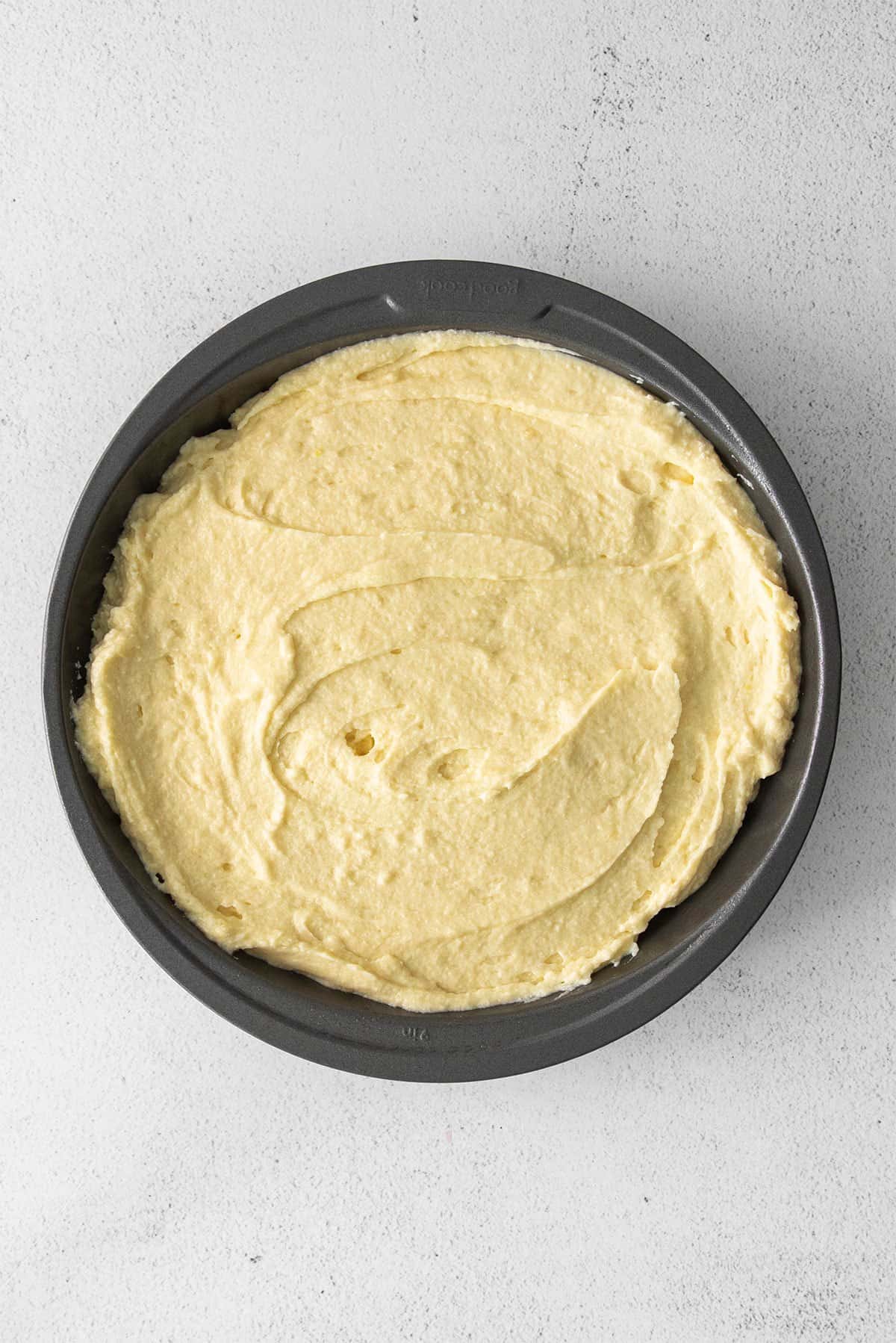 Ricotta cake batter in a cake pan. 