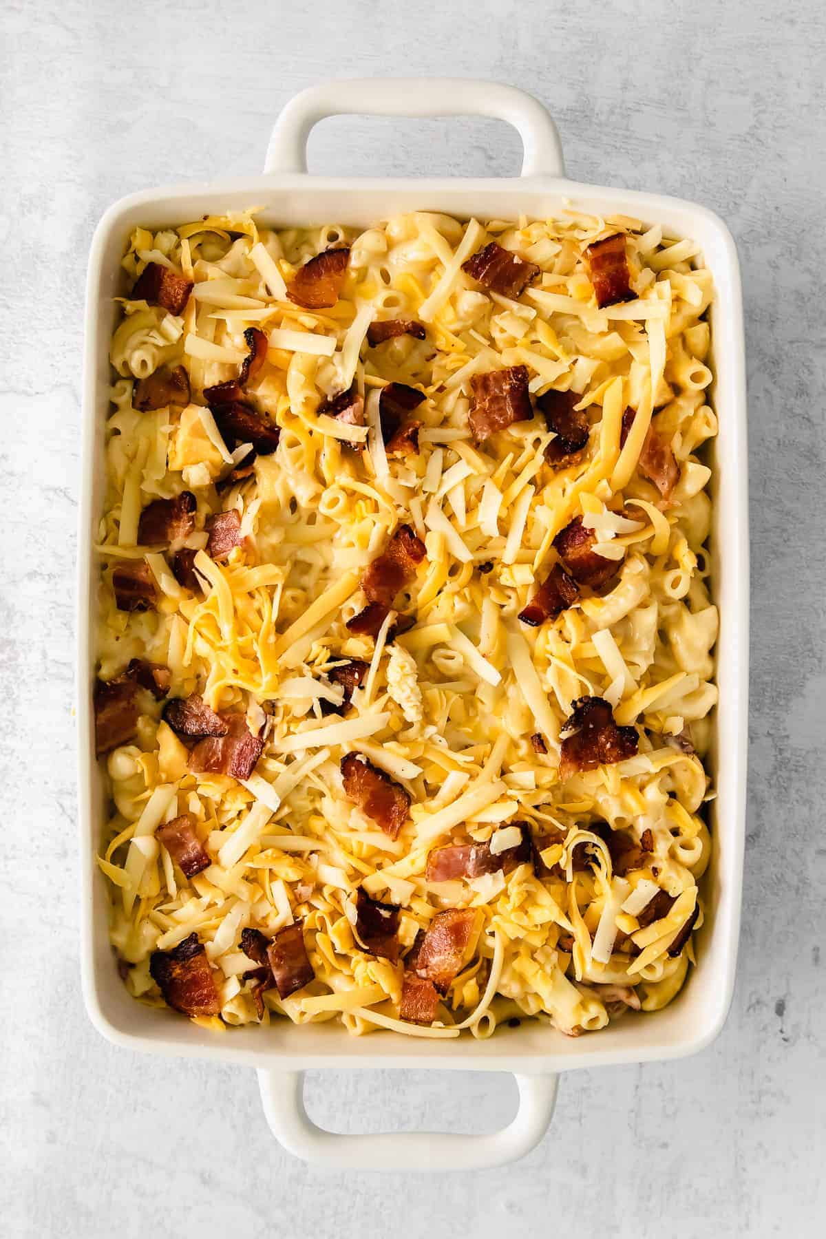 Bacon mac and cheese in a casserole dish. 