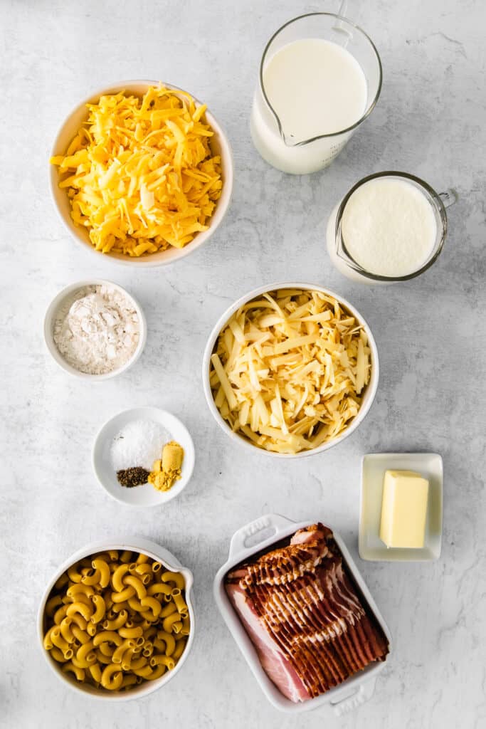 The ingredients for bacon mac and cheese in small dishes. 