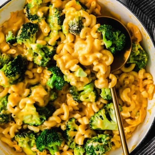 a bowl of macaroni and cheese with a spoon.