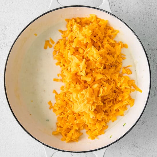 cheesy rice in a pan on a white background.