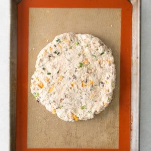 a piece of chicken fried steak on a baking sheet.