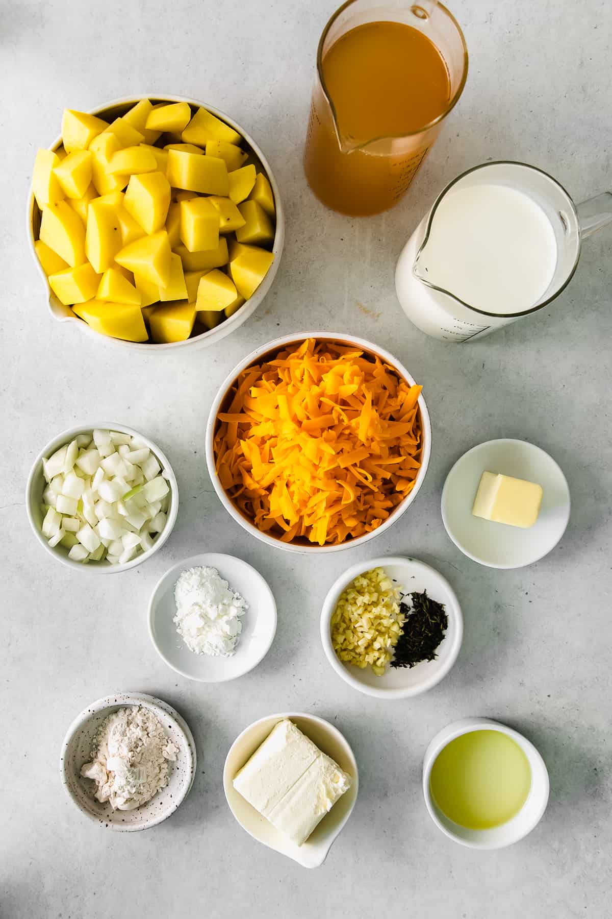 ingredients for cheesy potato soup in bowls.