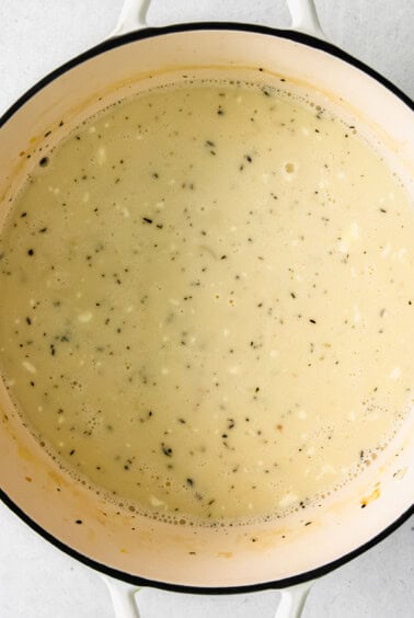 soup in a pot on a white surface.