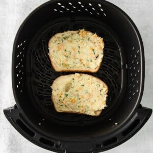 Two slices of Texas toast cooked in an air fryer.