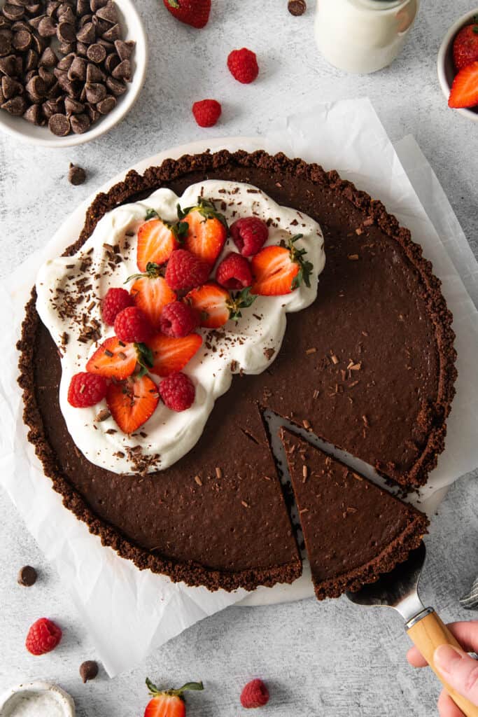 Chocolate tart with whipped cream, strawberries, and raspberries. 