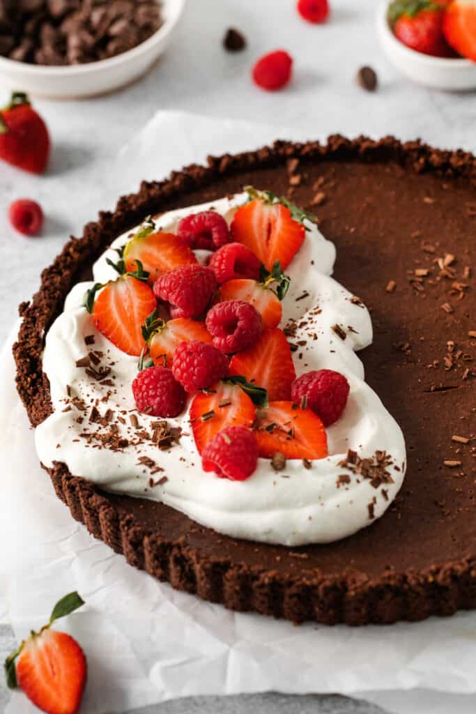 chocolate tart with whipped cream and fresh berries. 
