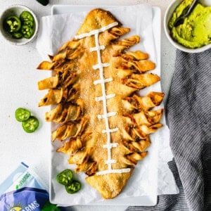 Cheesy football nachos with jalapenos and guacamole.