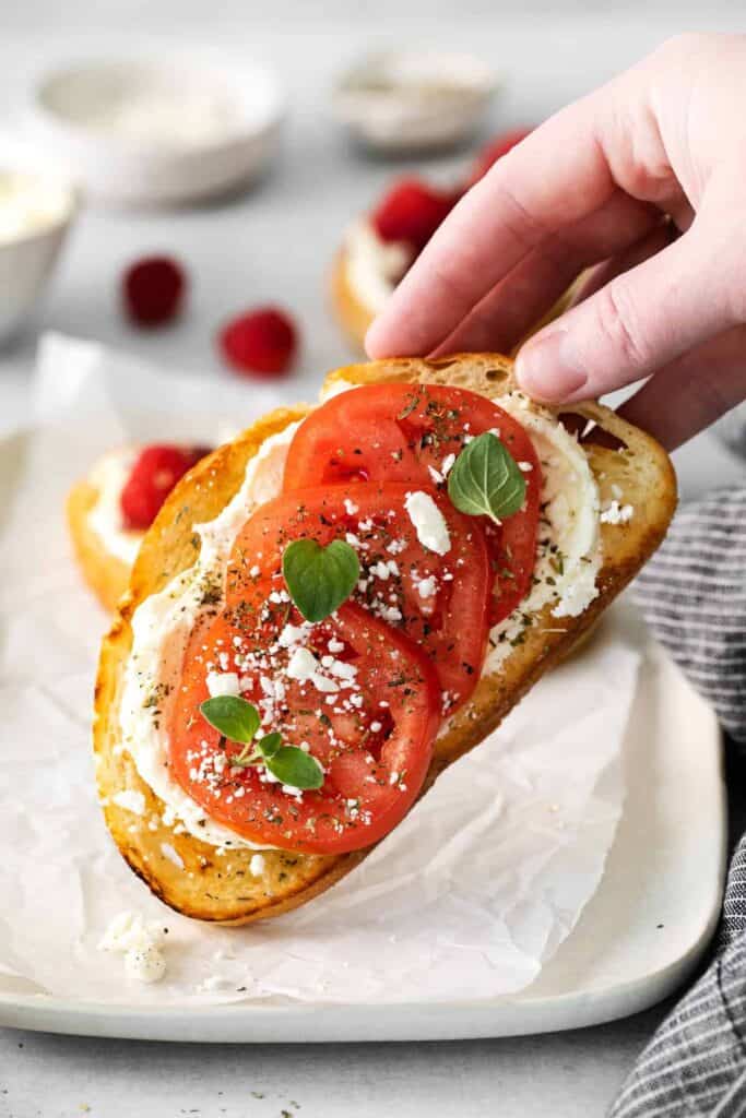 mascarpone toast with tomatoes and basil and feta on top of it