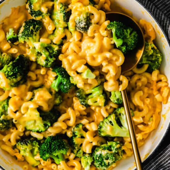 a bowl of macaroni and cheese with a spoon.