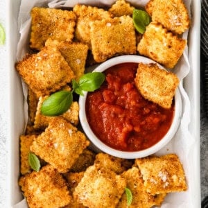 Air Fryer Ravioli served next to marinara sauce.