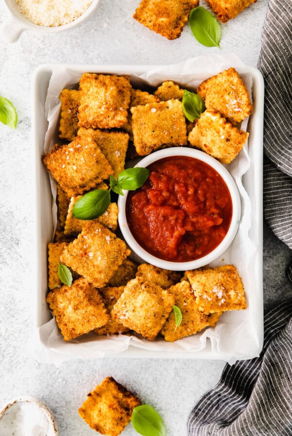 Air Fryer Ravioli served next to marinara sauce.