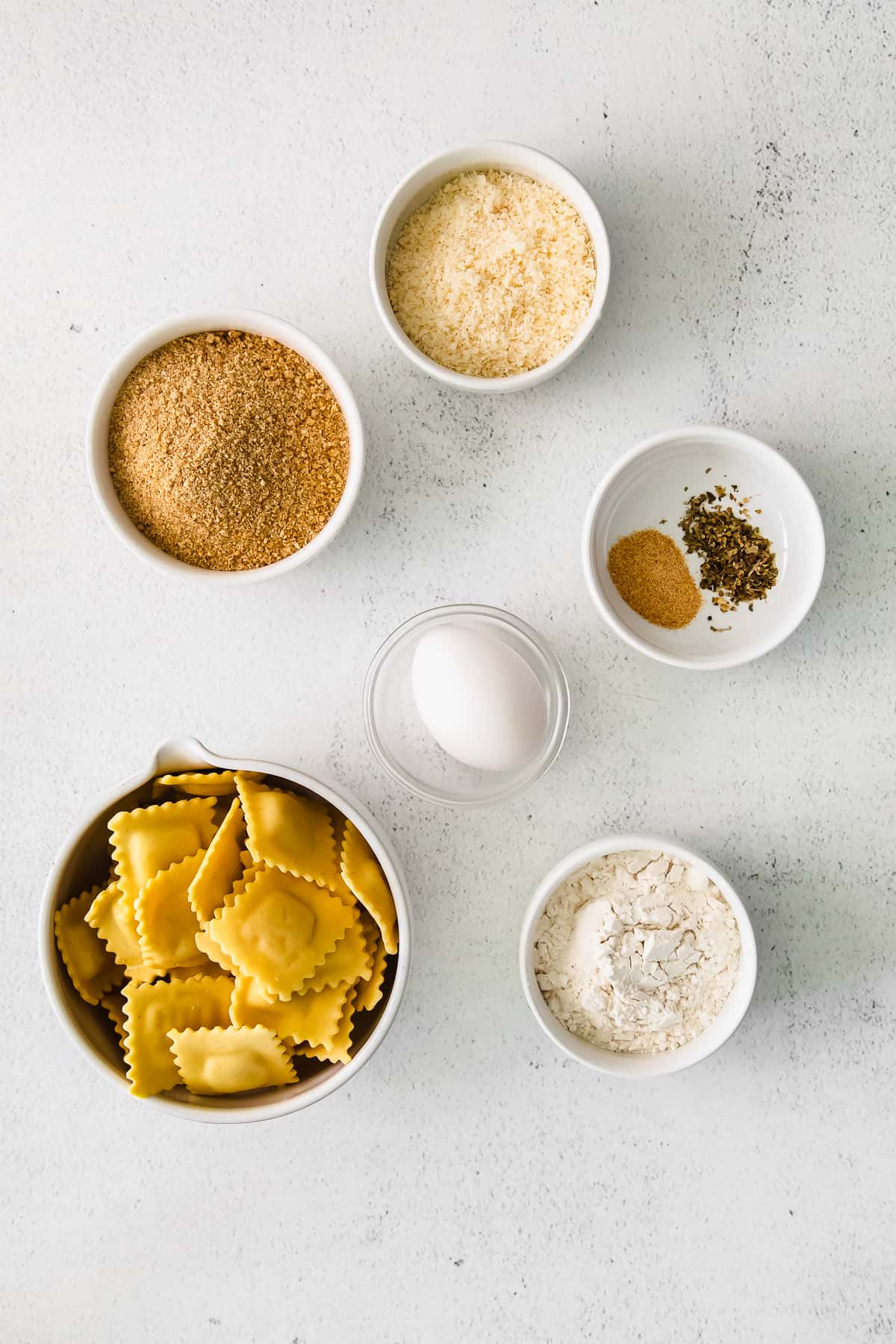 Ingredients for the air fryer ravioli in small pinch bowls. 