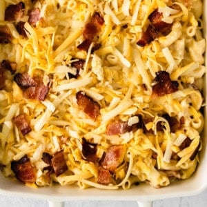 macaroni and cheese with bacon in a white baking dish.