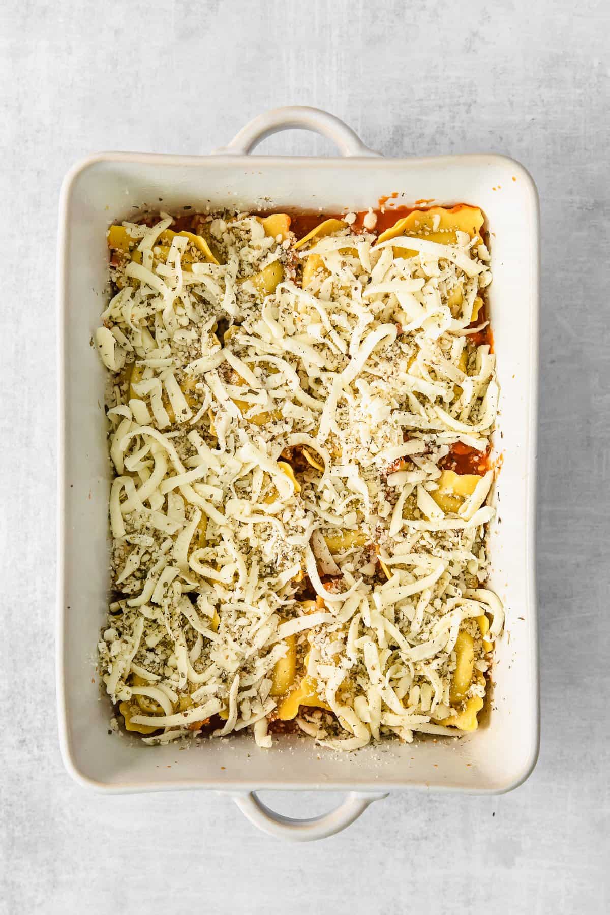 Baked ravioli in a casserole dish pre-baking. 