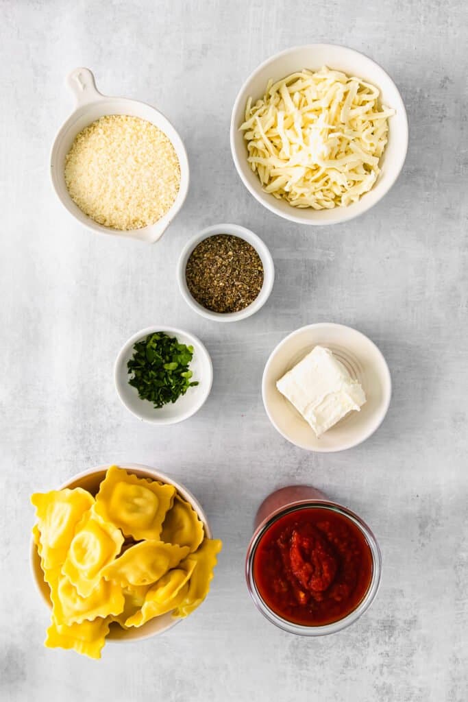 Ingredients for baked ravioli in small dishes. 