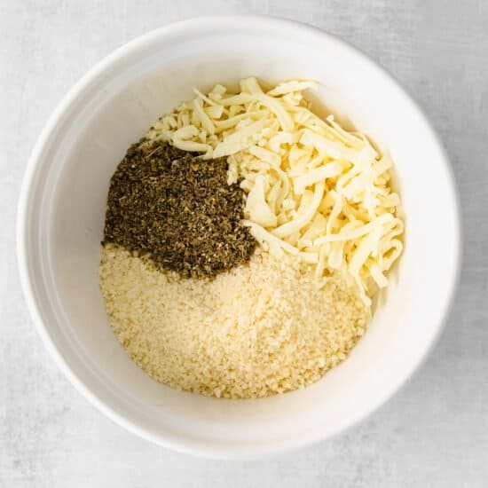 Cheese and spices in a mixing bowl.