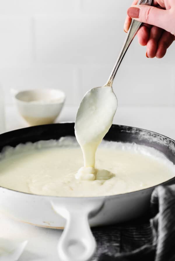 spoon dripping bechamel sauce.