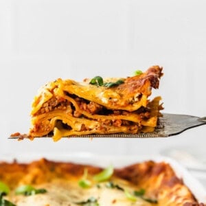 a slice of lasagna being lifted off a fork.