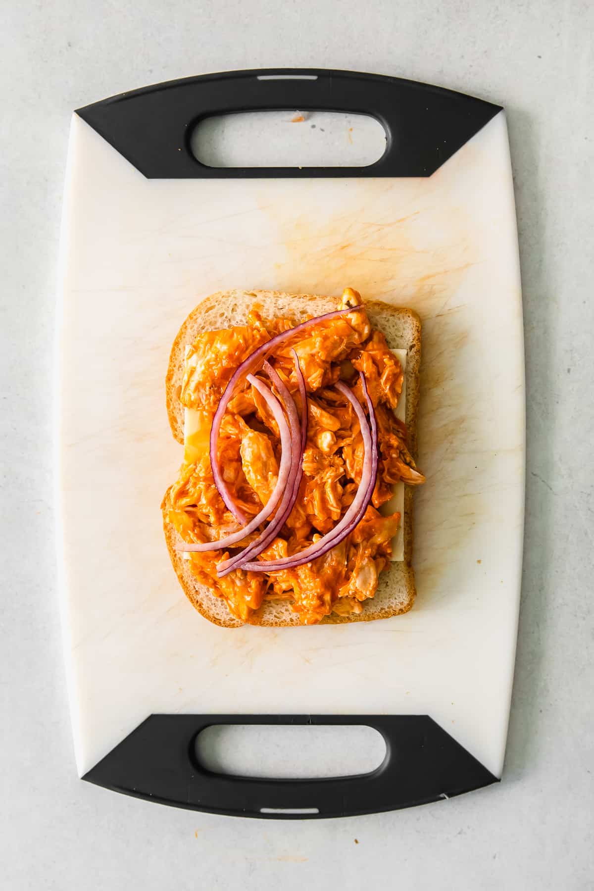 open face grilled cheese on cutting board.