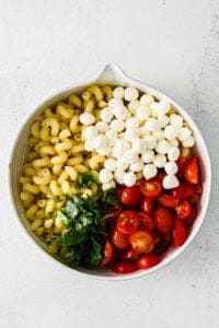 Caprese Pasta Salad ingredients in a bowl.