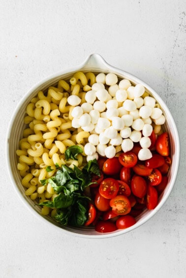 Caprese Pasta Salad ingredients in a bowl.