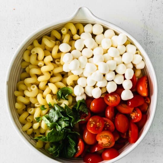 Caprese Pasta Salad ingredients in a bowl.