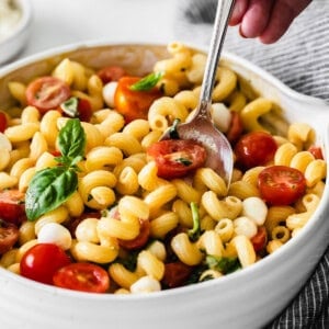 Caprese Pasta salad with dressing on top.